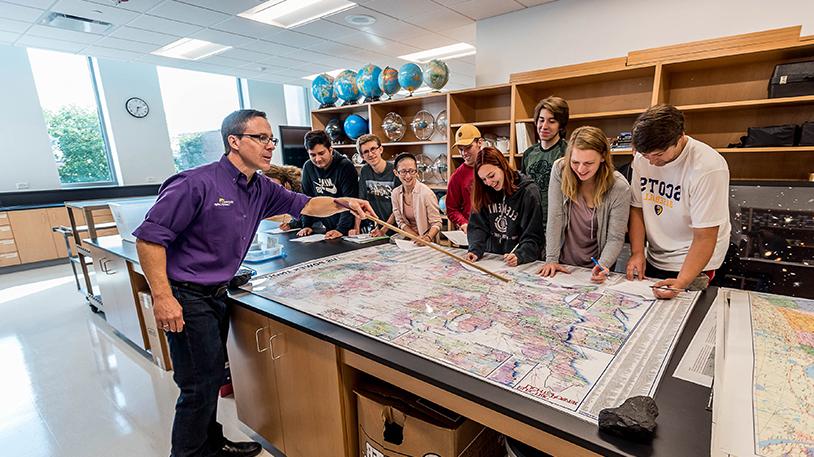 Ted Erski showing students a map